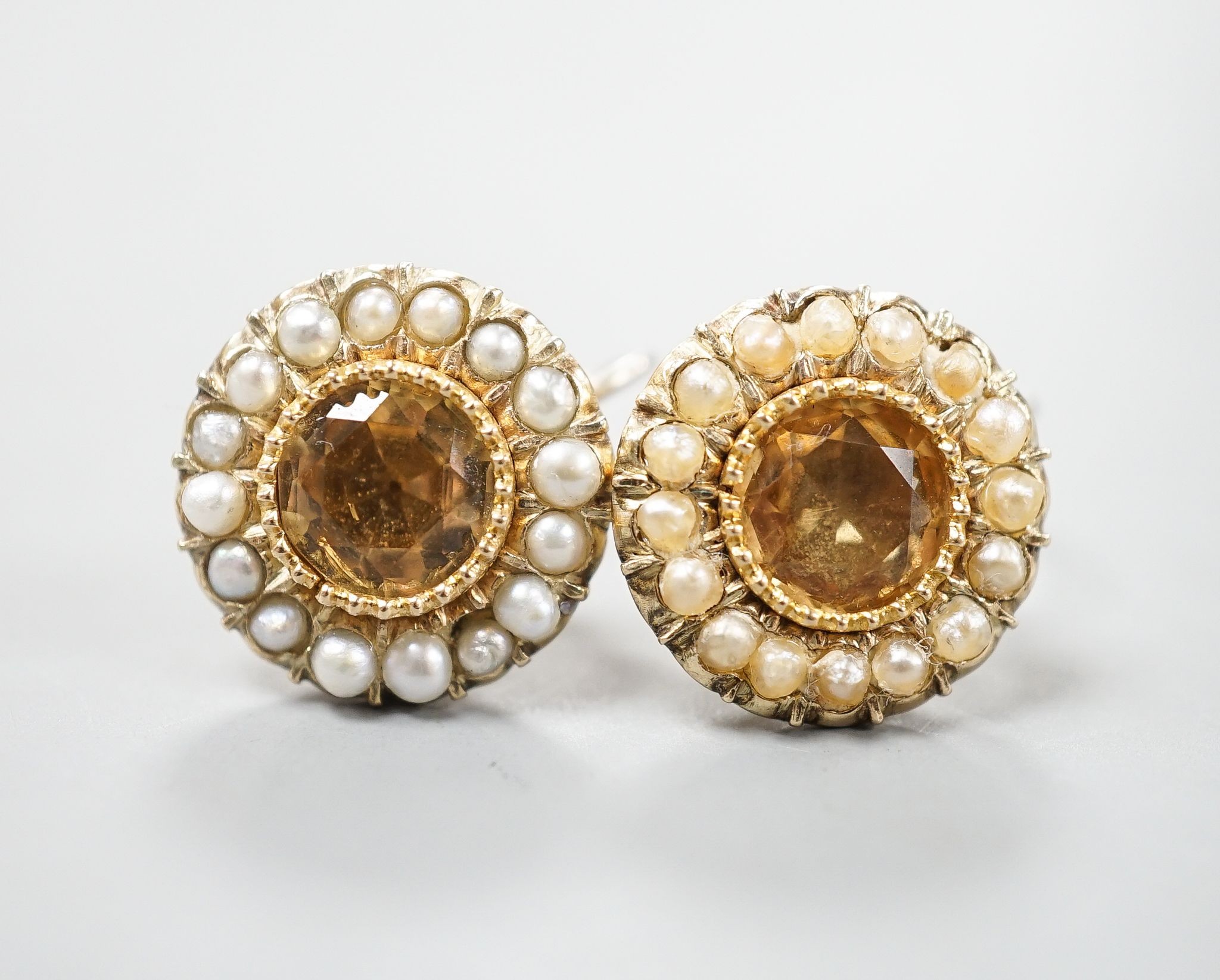 A pair of yellow metal, yellow topaz and split pearl set ear clips(adapted?), 14mm, gross 5.8 grams.